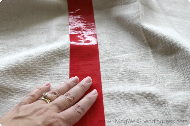 Lay a strip of duct tape at the folds of the cloth to mark out the game board spaces. 