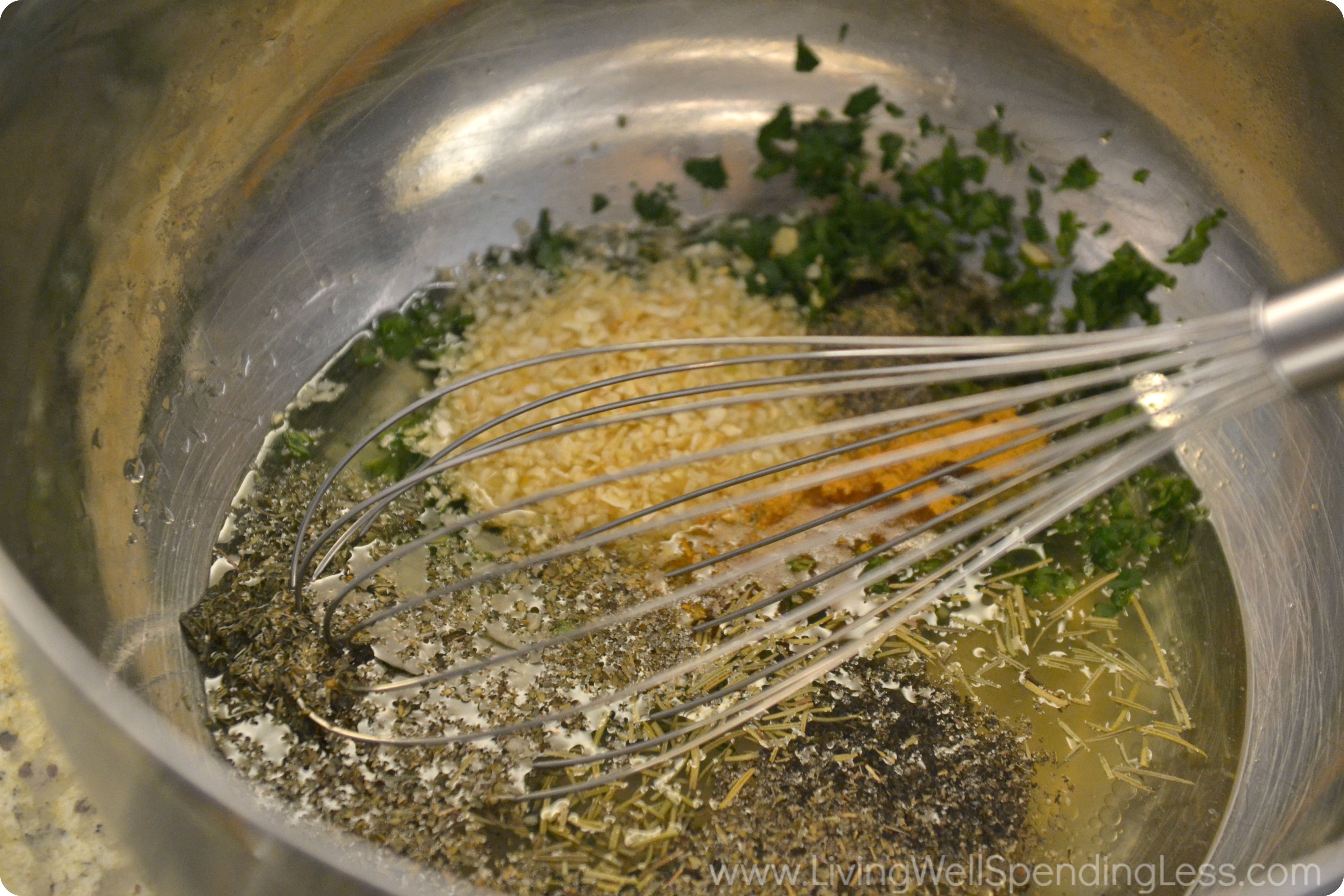 Compose the sauce by whisking together herbs, garlic, olive oil and seasonings in a bowl. 