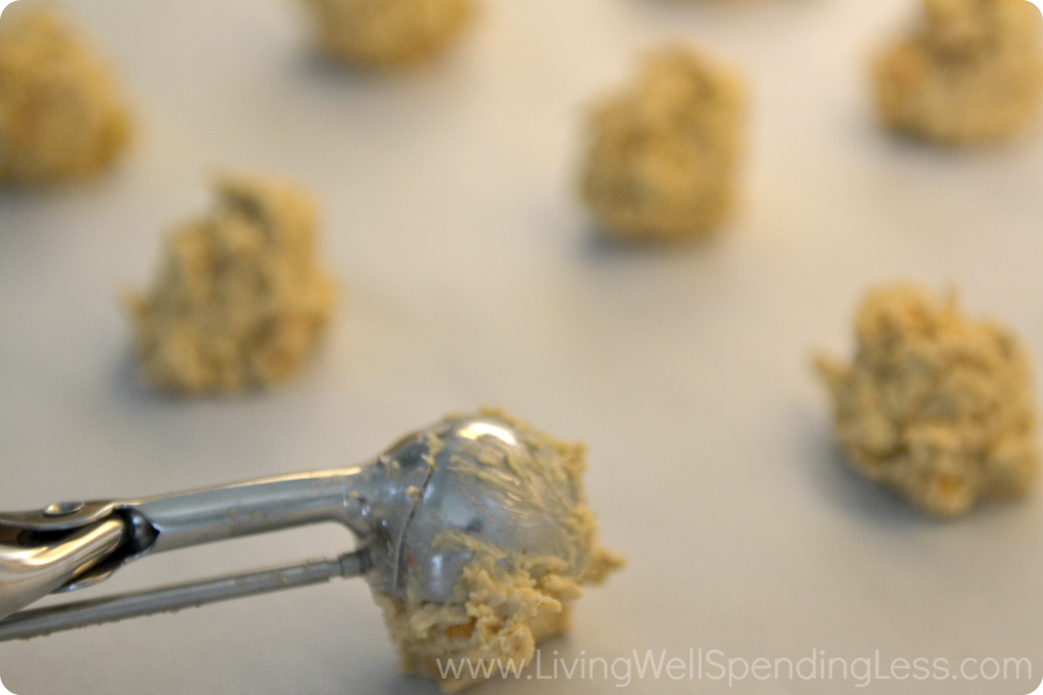 Use an icecream scoop to get uniform cookies on a parchment sheet. 