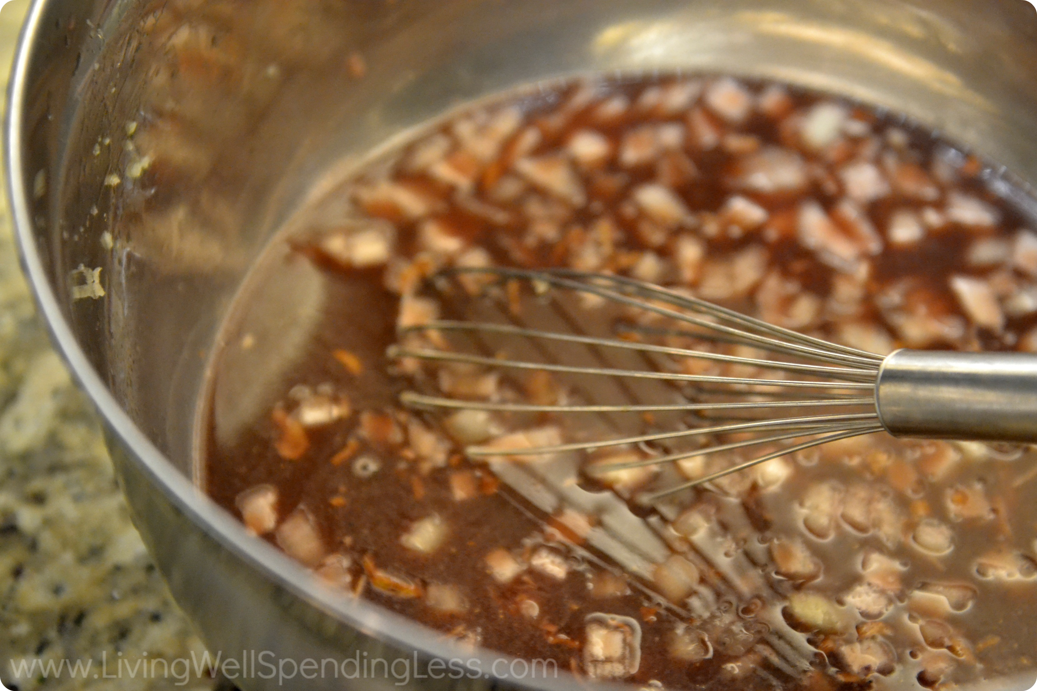 Whisk together the soup mix, sauce, onion and garlic. 