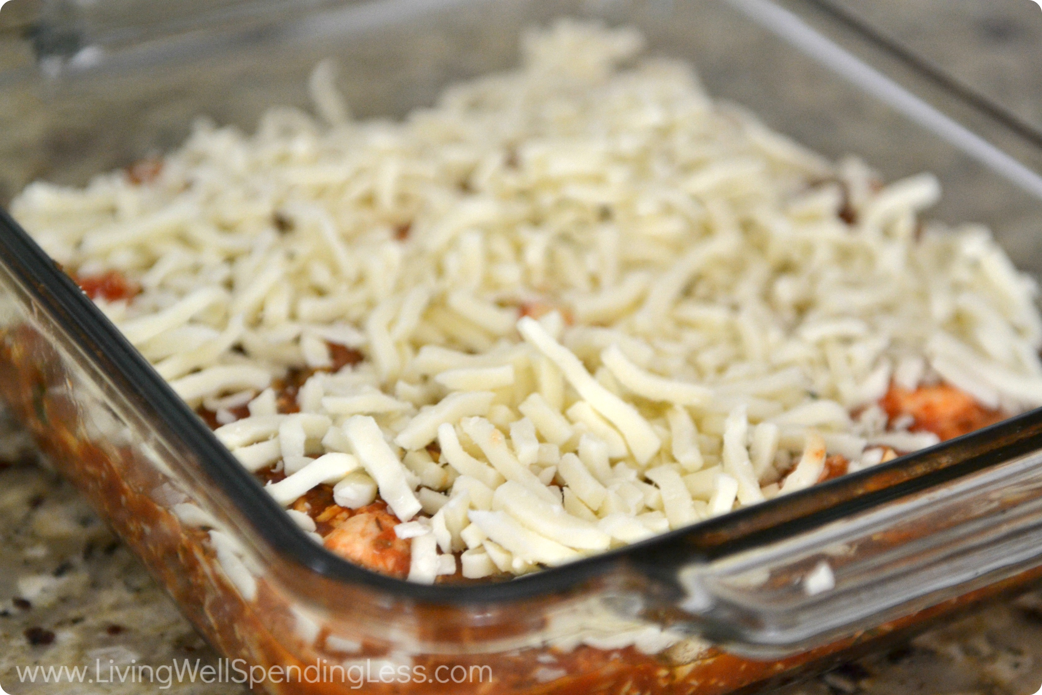 Pour mixture over chicken in a casserole dish and cover with shredded cheese.