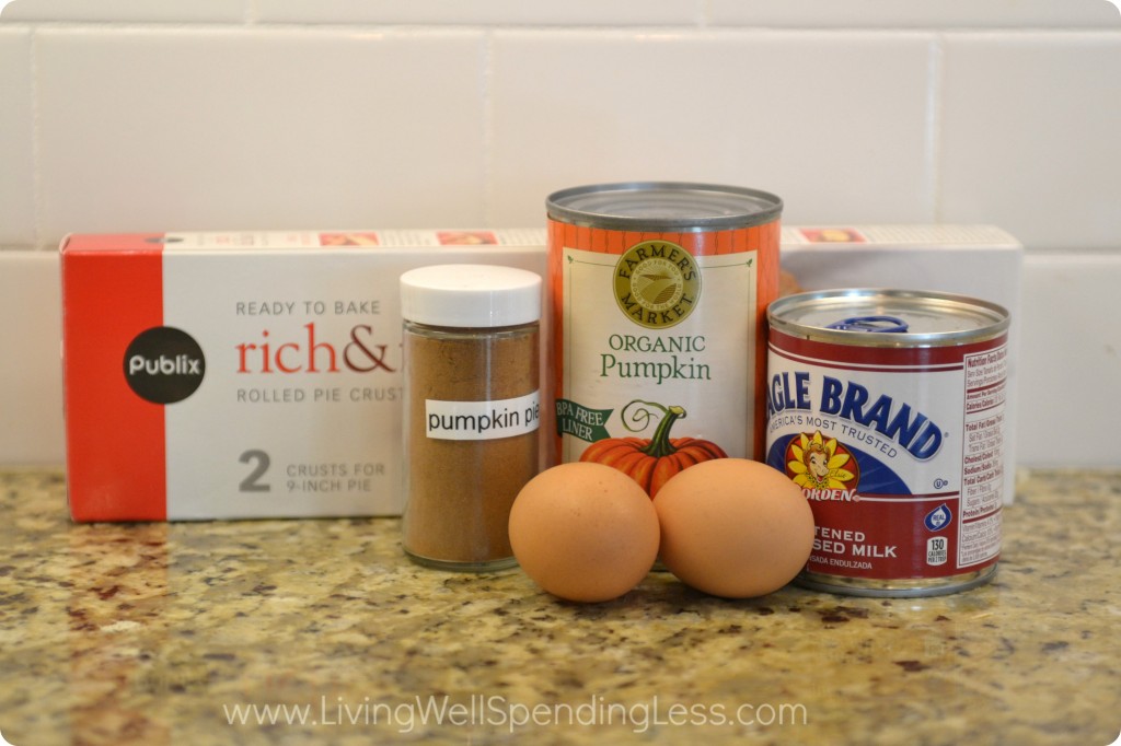 Assemble the simple ingredients for this pumpkin pie: pie crust, pumpkin, condensed milk, eggs, and spice. 