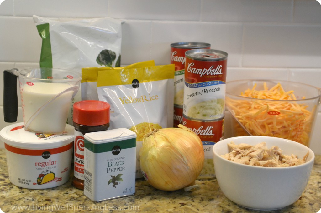 Assemble the ingredients for this cheesy chicken casserole: sour cream, pepper, milk, cream of broccoli soup, cheese, chicken, onion, rice and broccoli. 