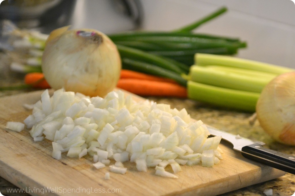 Dice the onion for your cheesy chicken broccoli casserole. 