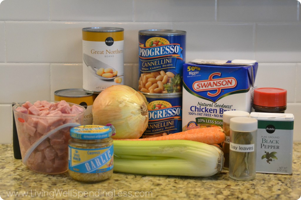 Assemble the ingredients for this ham bean soup: beans, celery, carrots, spices, onions and ham.