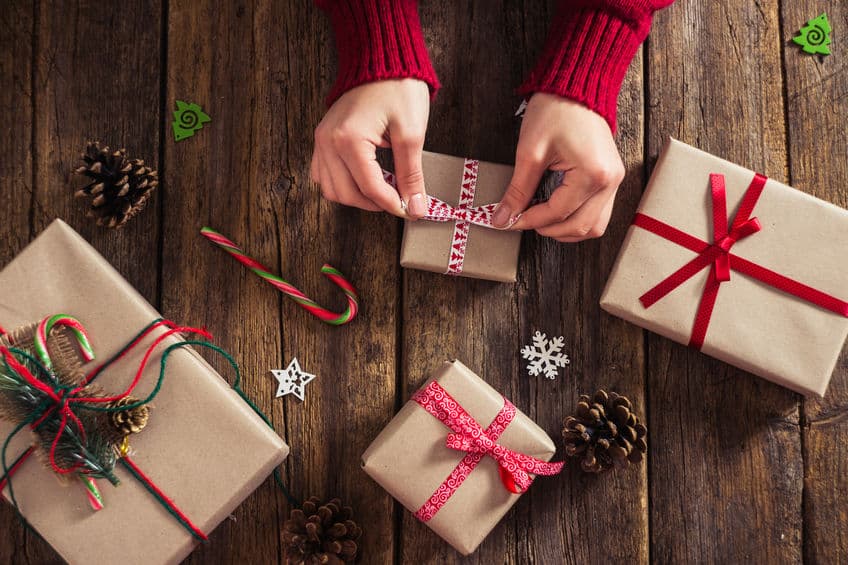 Use plain brown bags to wrap gifts. Add color with ribbons and bows.