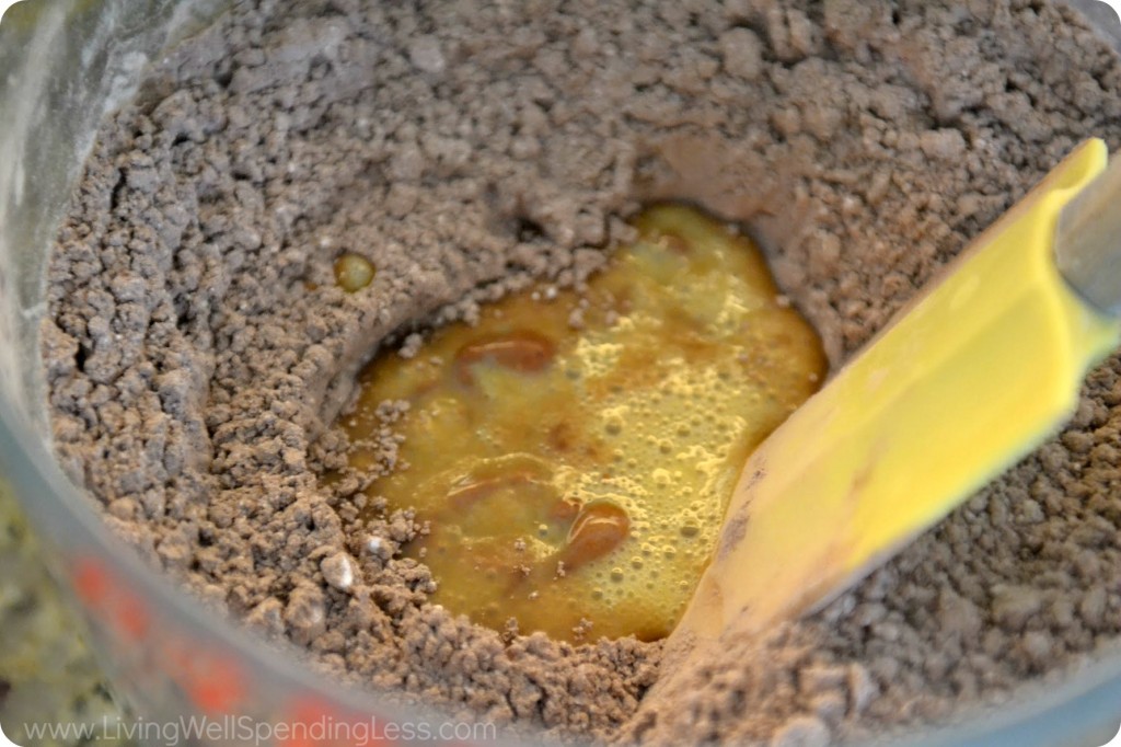 Create a well with a spatula and add the egg to the dry ingredients for your chocolate cookies. 