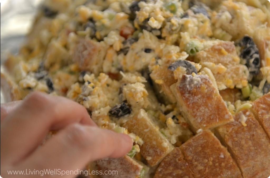 Stuff olive mixture into bread, between cut pieces