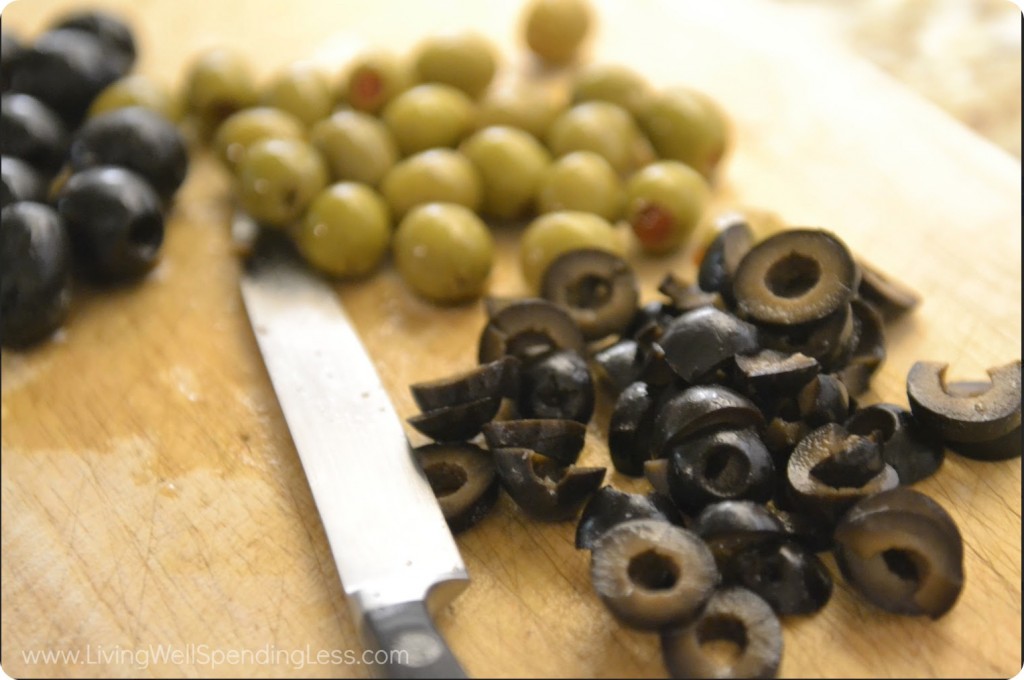 Slice the black and green olives