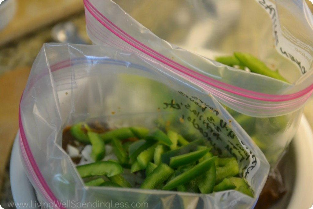 Add onions and green peppers to each freezer bag.