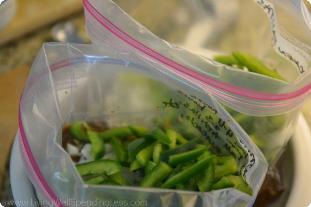 Add onions and green peppers to each freezer bag.