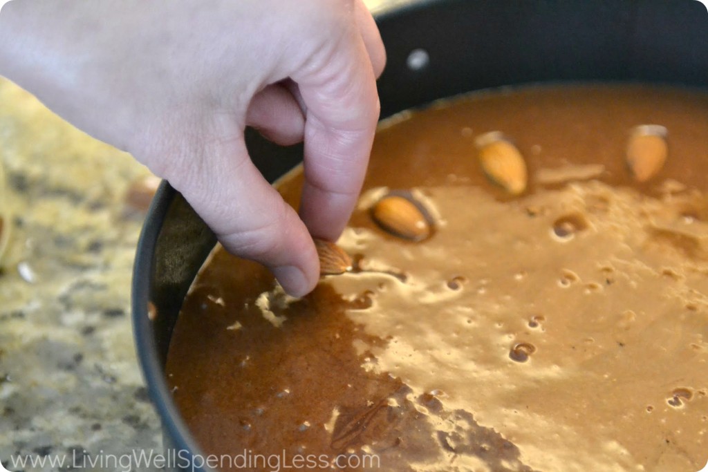 Gently arrange whole almonds on top of batter.