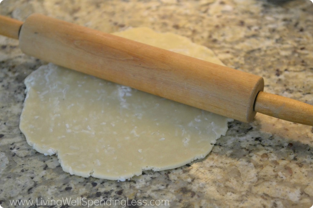 Knead together almond paste, shredded coconut and powered sugar on a flat work surface then roll out. 