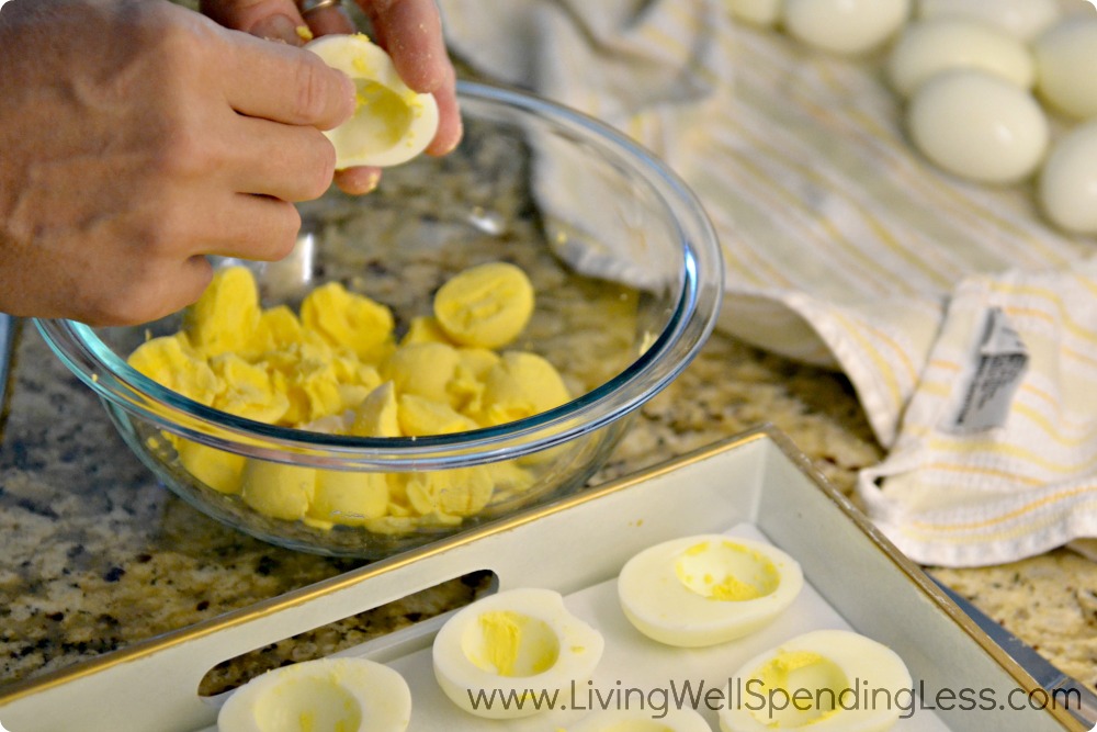Cut eggs in half lengthwise; gently scoop yellow yolks into medium size bowl.