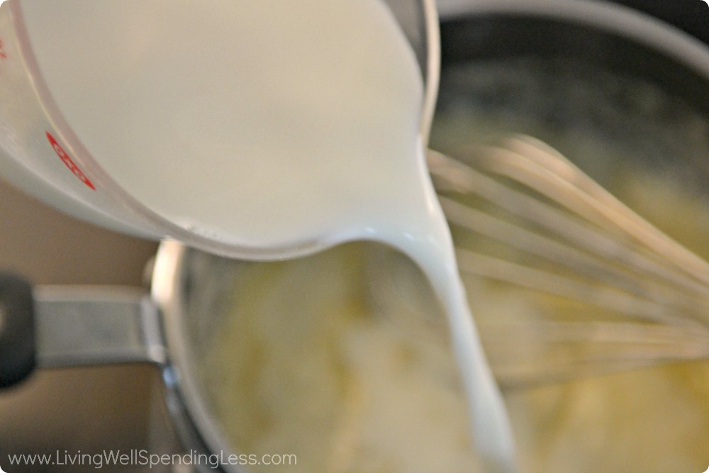 Pour the heavy cream into the mixture of flour and butter for this creamed spinach casserole. 