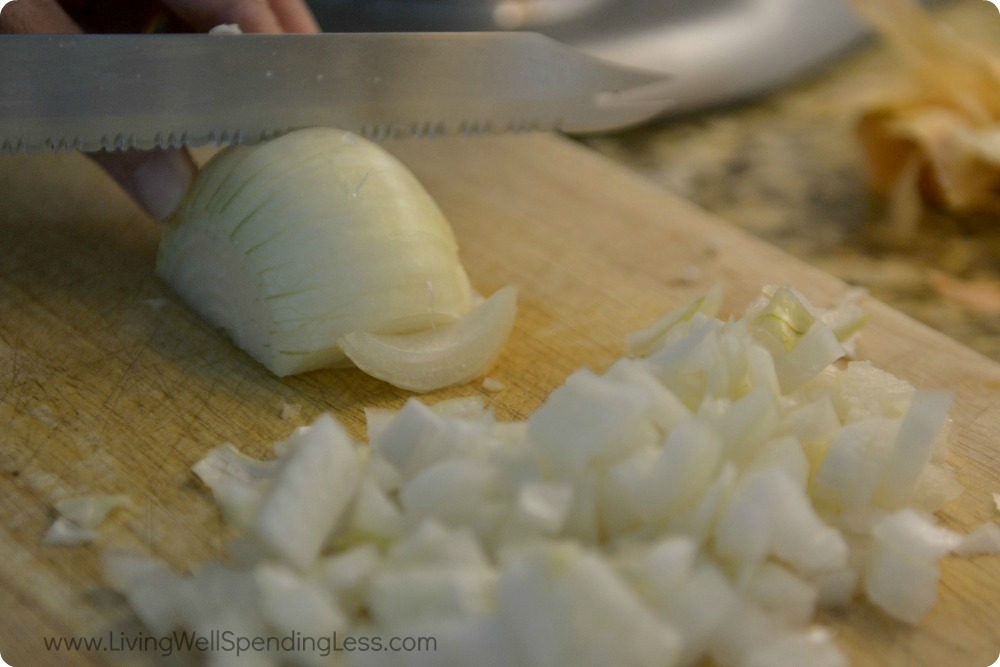 Use a kitchen knife to finely dice a white onion and set aside. 