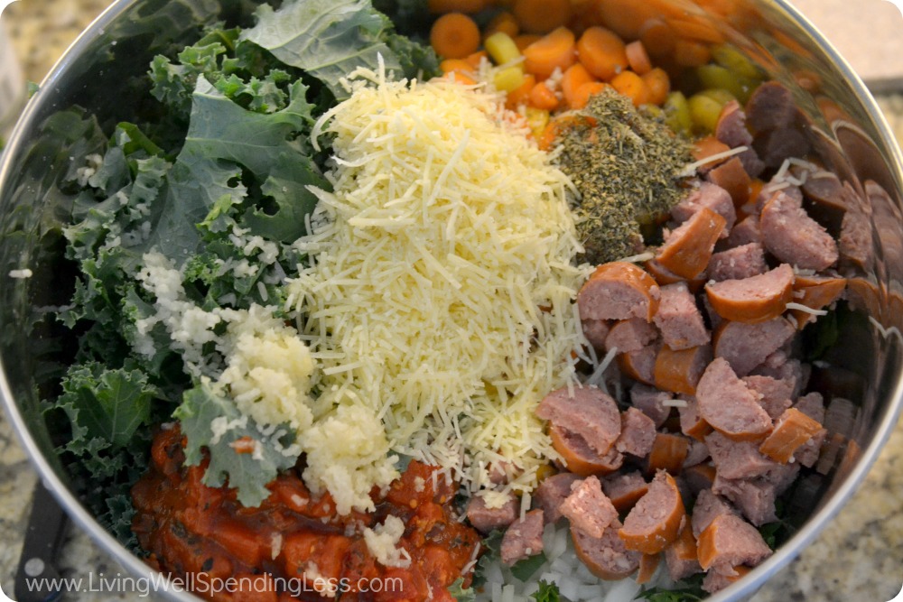 Add the kale, sausage, tomatoes and chopped veggies to a bowl and top with the shredded cheese. 