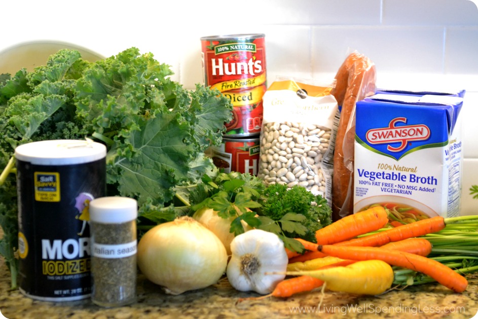 Gather the ingredients for this soup: kale, white beans, vegetable broth, onions, carrots, tomatoes and seasonings.