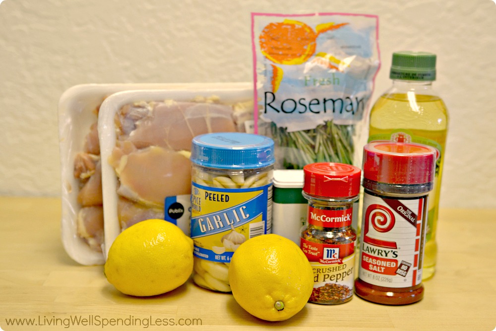 Assemble the ingredients for this easy Greek chicken: lemon, rosemary, garlic, seasonings and of course, chicken.