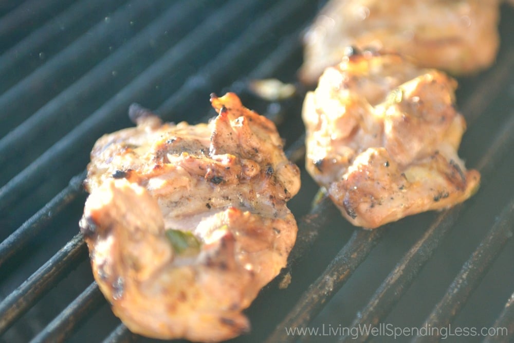 Cook marinated chicken on the grill 