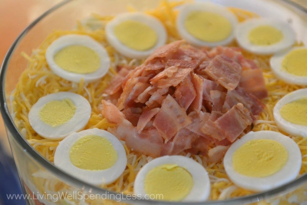 Add sliced eggs and bacon to top off this beautiful layered salad. 