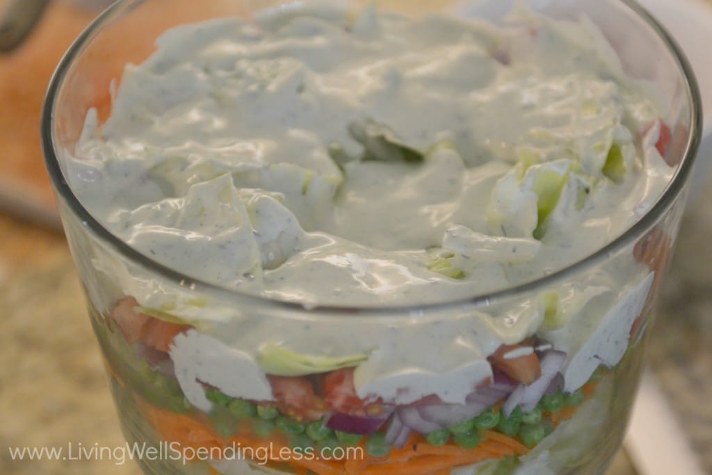 Top the seven layer salad with dressing so it can mix into all seven layers. 