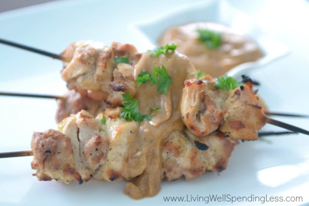 Pour peanut sauce over chicken skewers and serve.