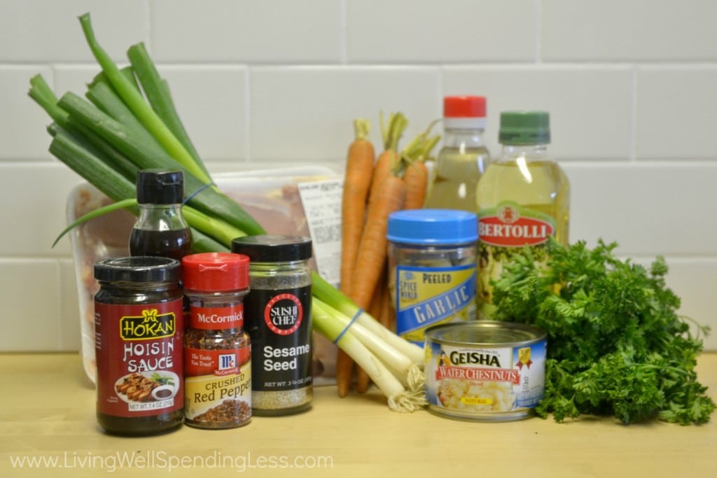 Assemble all the ingredients for these easy lettuce wraps: water chestnuts, garlic, oil, seasonings and onions.