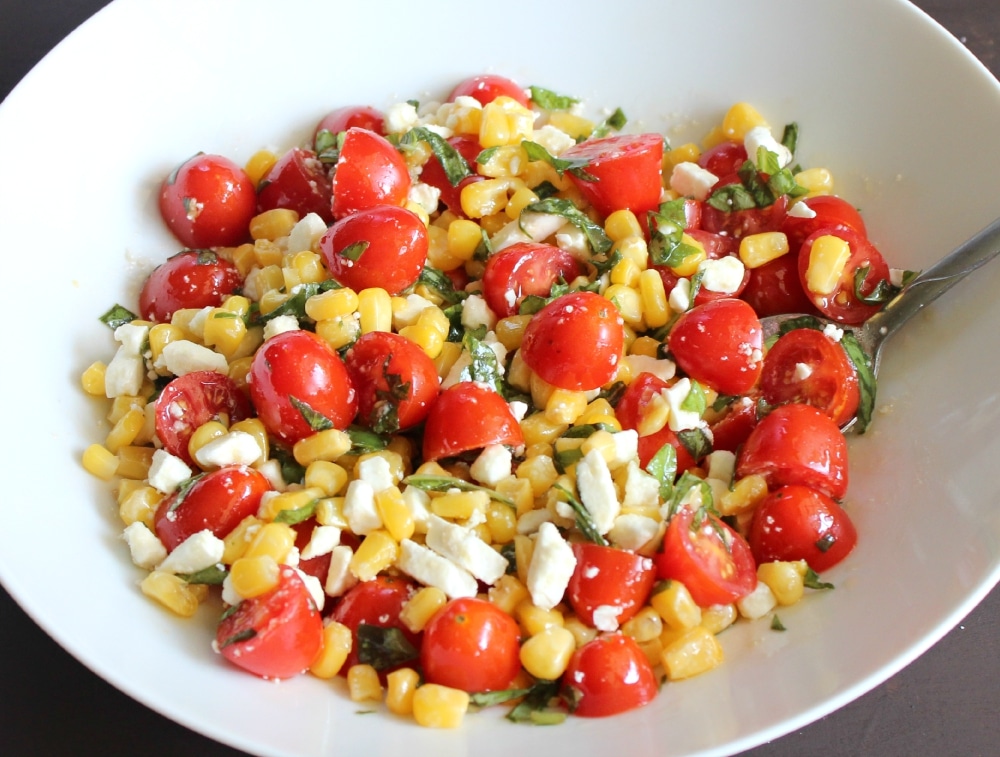 Combine the cherry tomatoes, corn, basil, and feta cheese. 