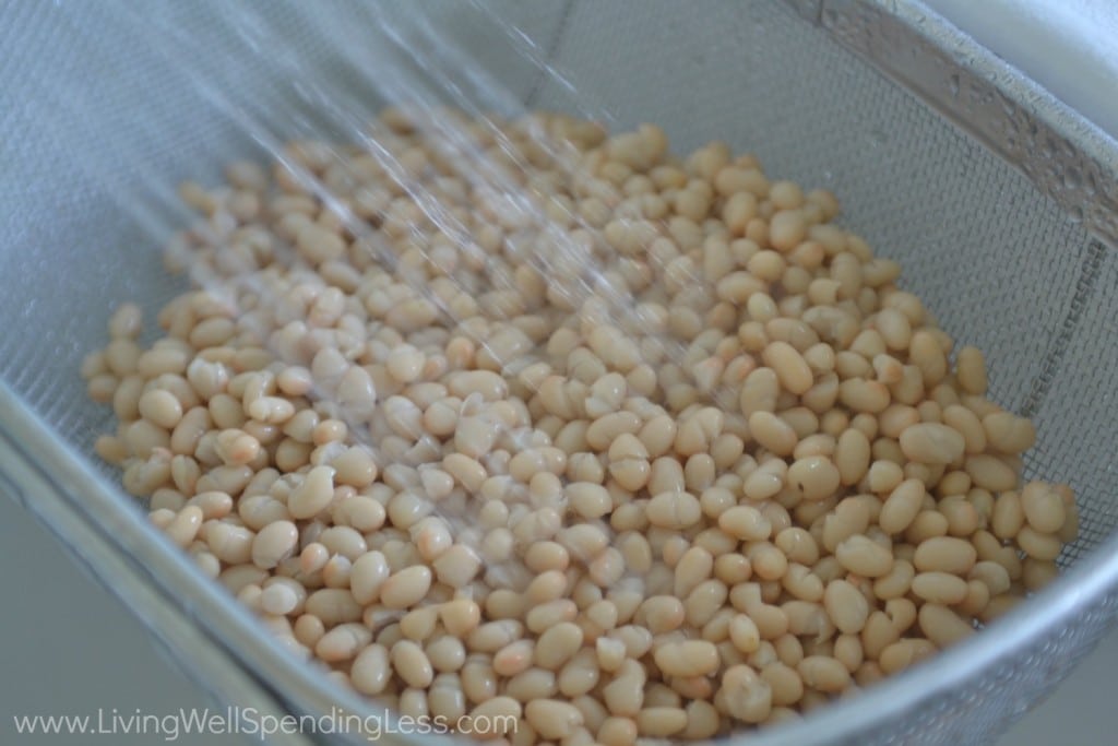 Rinse and drain white beans in the sink. 