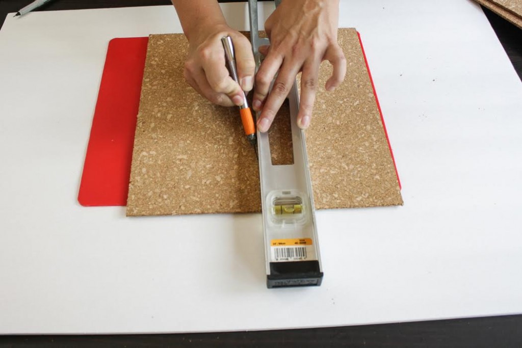 Cut the cork tile in half using a ruler and craft knife. 