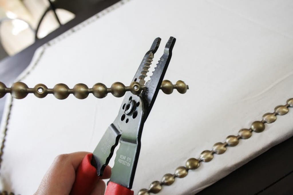 Use wire cutters to measure the nail head trim and adjust the length accordingly. 