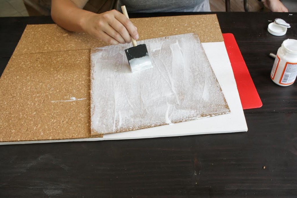 Apply Mod Podge to the cork tiles using a paint brush. 