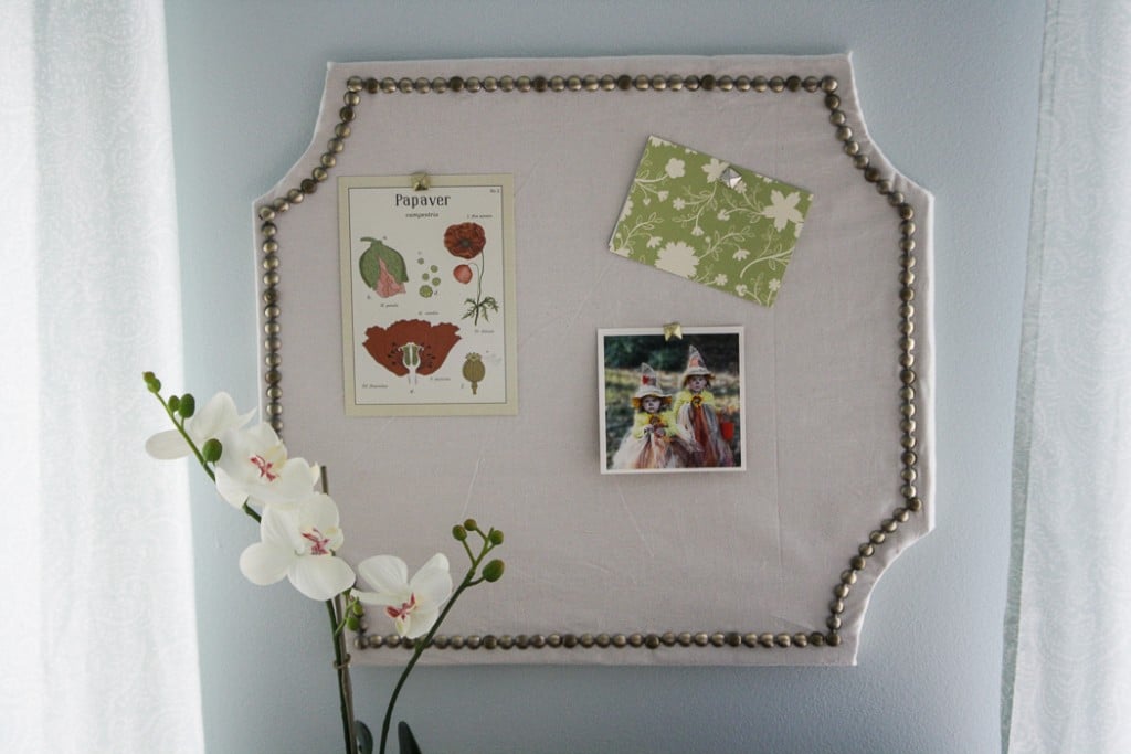 Once the cork board is finished, hang it up on the wall to display photos and notes. 