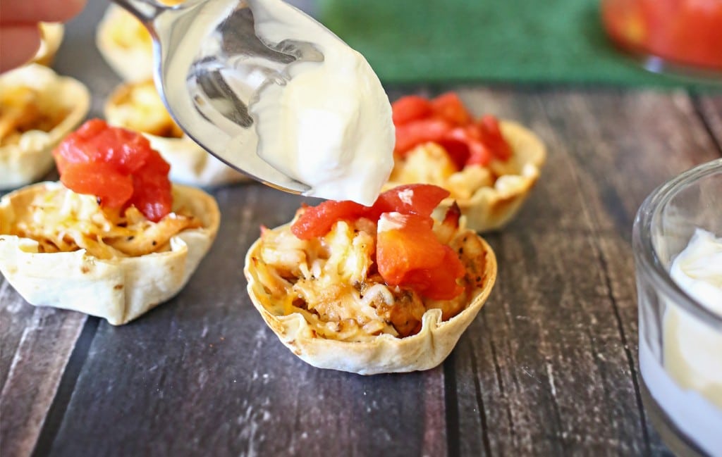 The last step of the easy taco cups recipe is to top with sour cream, delicious! 