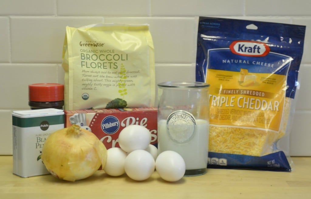 Assemble the veggie quiche ingredients: eggs, cheese, broccoli, pie crust and seasonings.