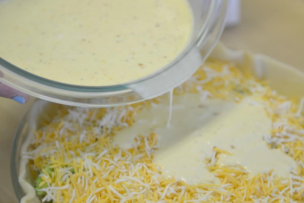 Pour the egg and cream mixture over the top of your shredded cheese and vegetables.