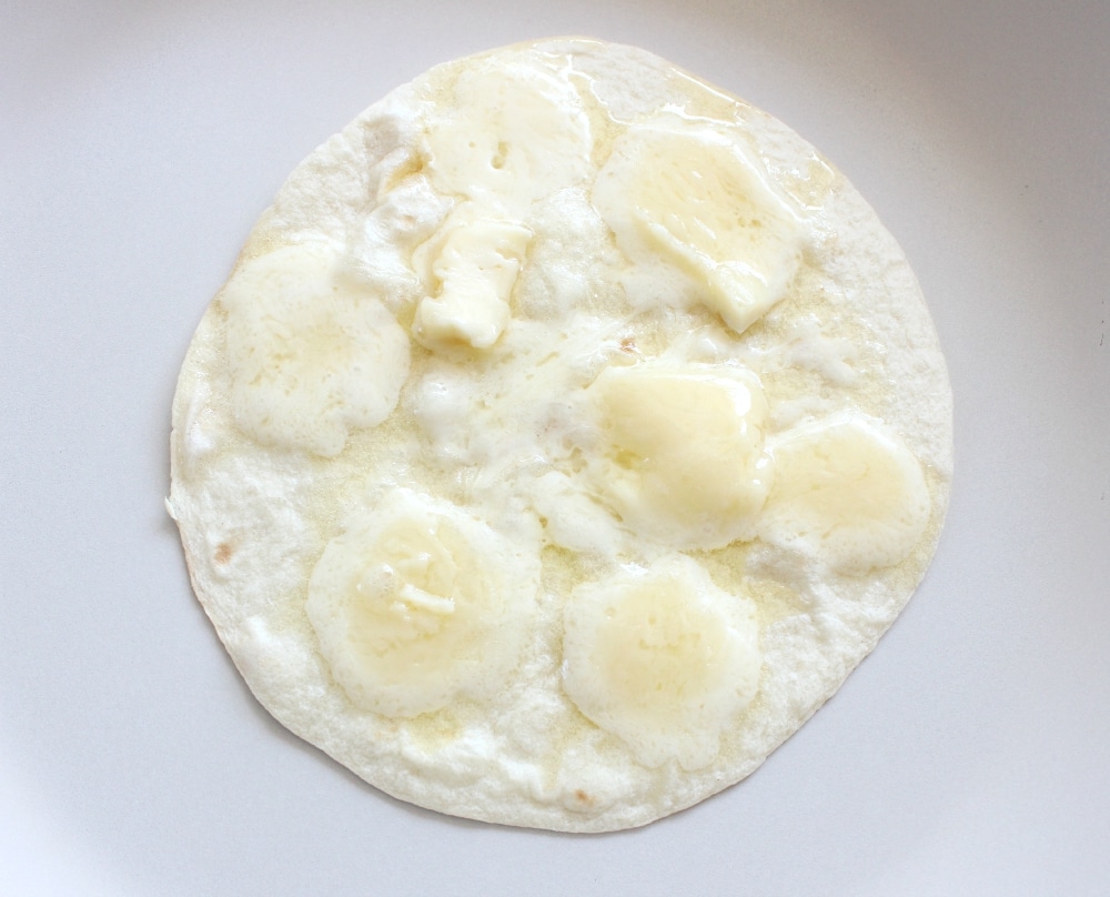 Cook the tortillas on a pan over medium heat until the cheese is melted