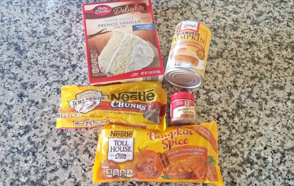 Assemble your ingredients: Vanilla cake mix, pumpkin pure, pumpkin pie spice, pumpkin spice morsels and chocolate chunks.