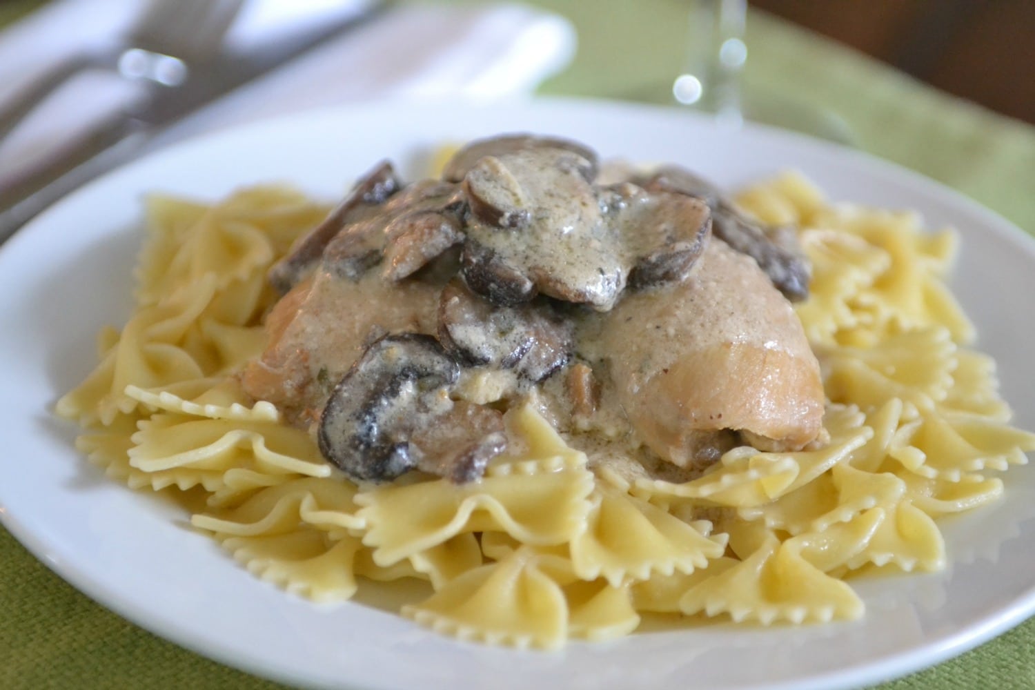 Once cooked, serve portobello chicken over noodles.