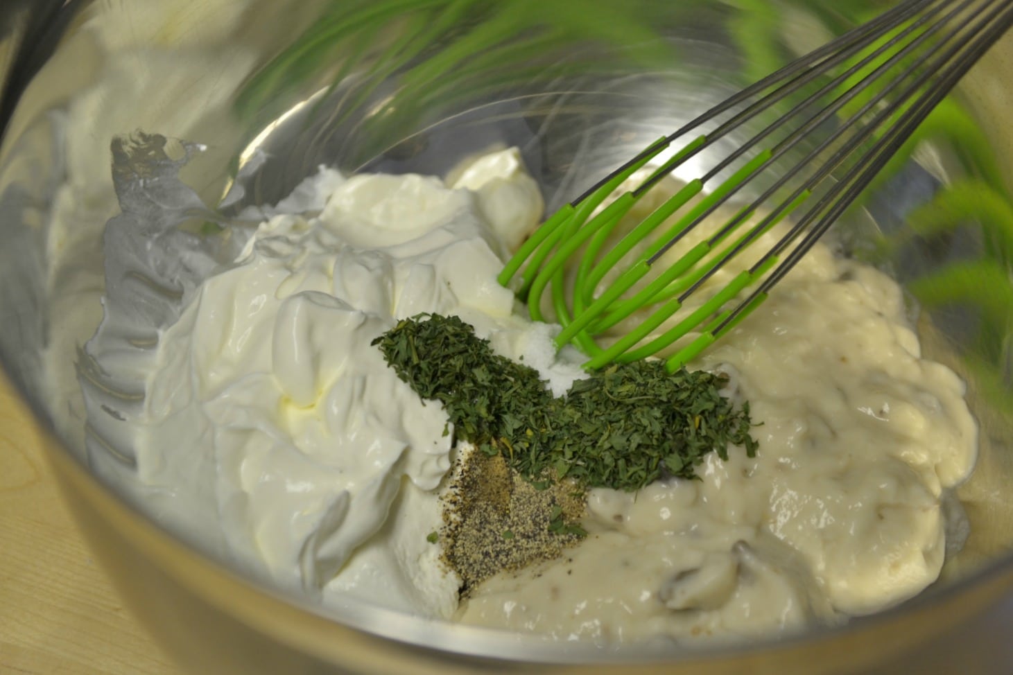 Whisk together soup, sour cream, mushrooms, parsley, salt and pepper in a bowl. 