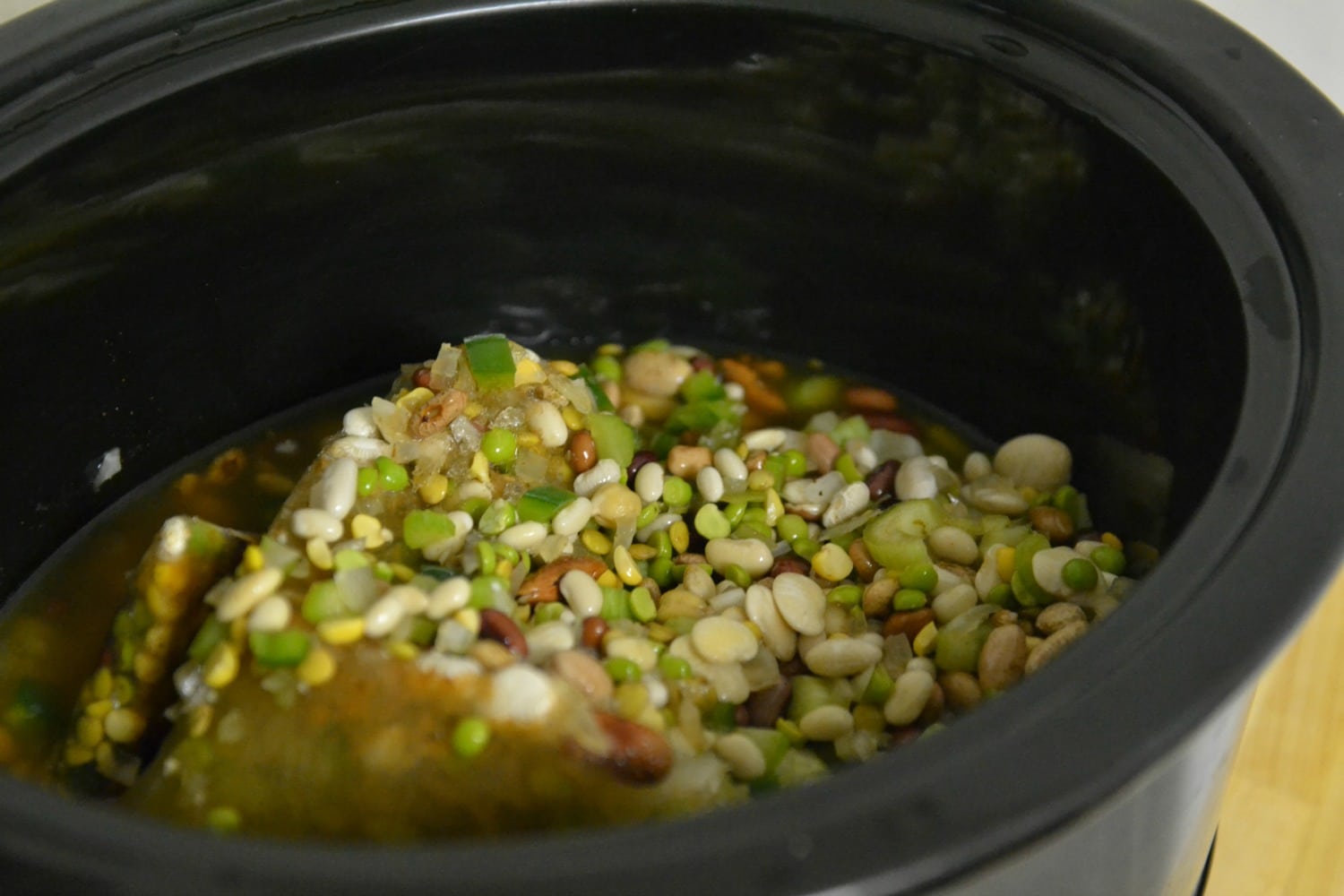 This Cajun bean soup heats up in the crock pot for a hearty, flavorful meal your kids will love!