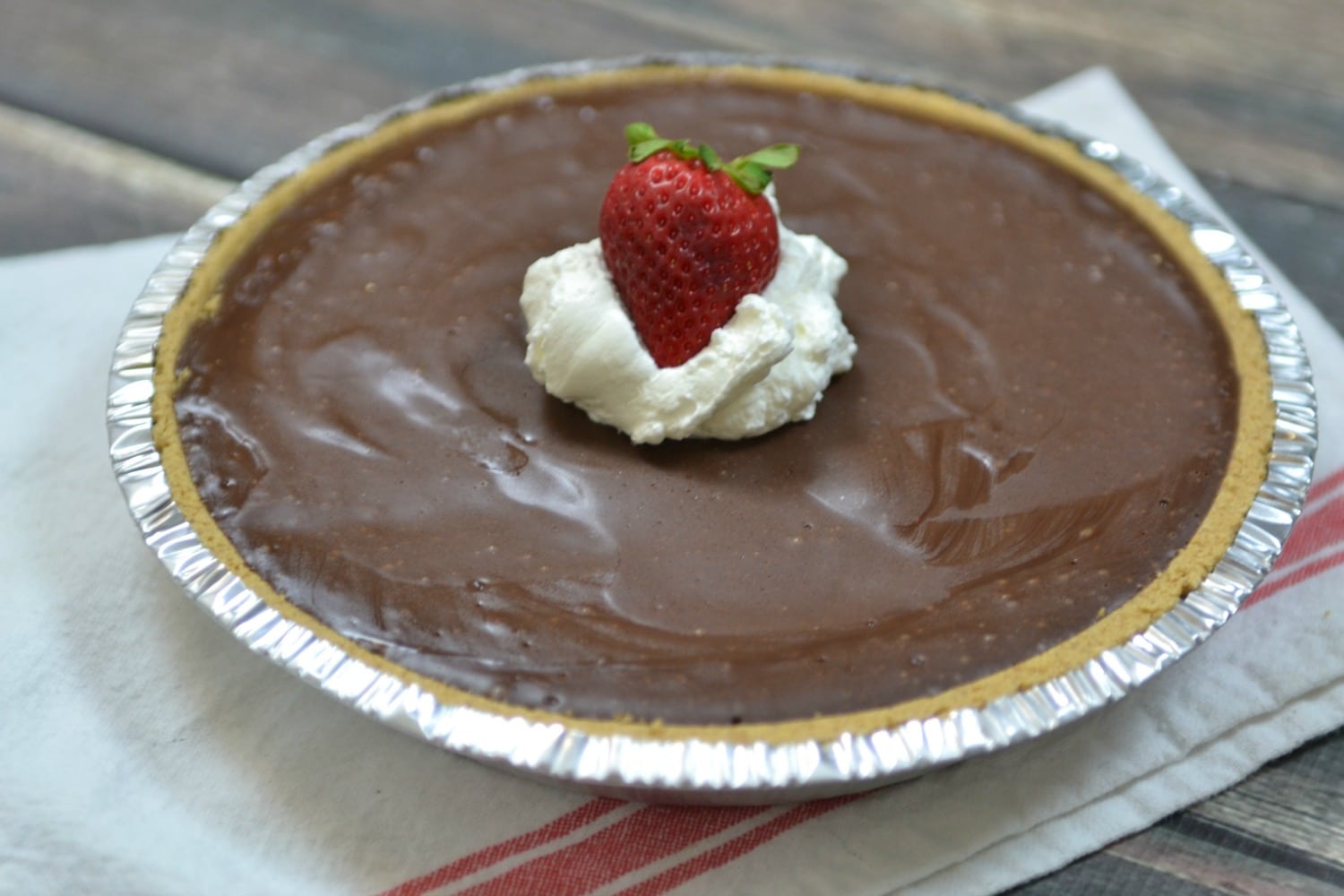 You can garnish your simple chocolate tart with whipped cream and strawberries, yum!