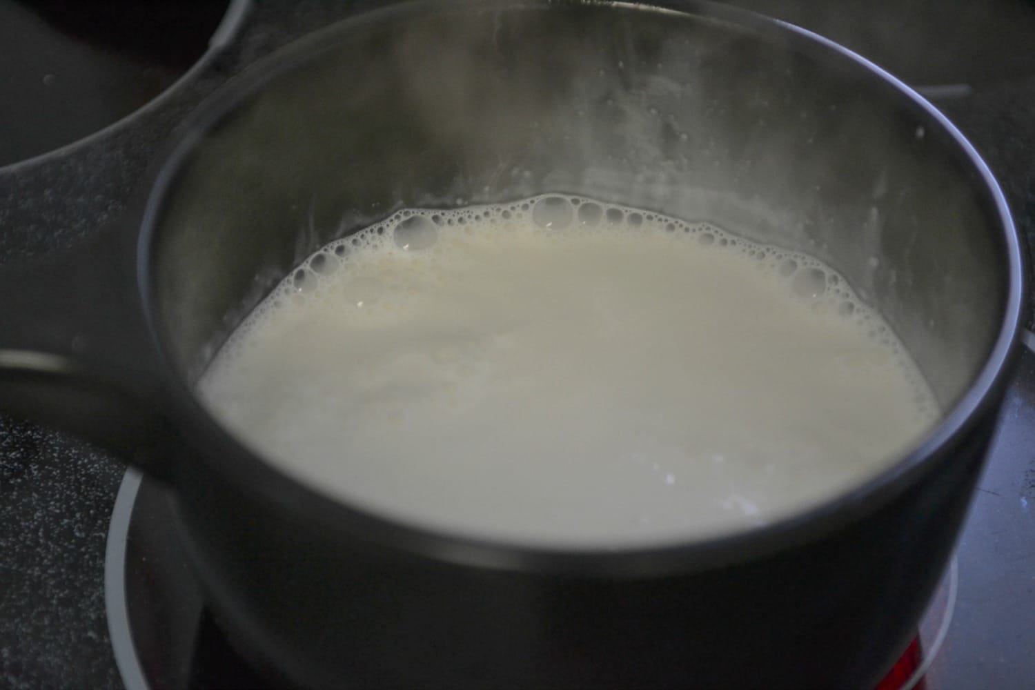 Step one for this simple chocolate tart is to bring heavy cream to a boil. 