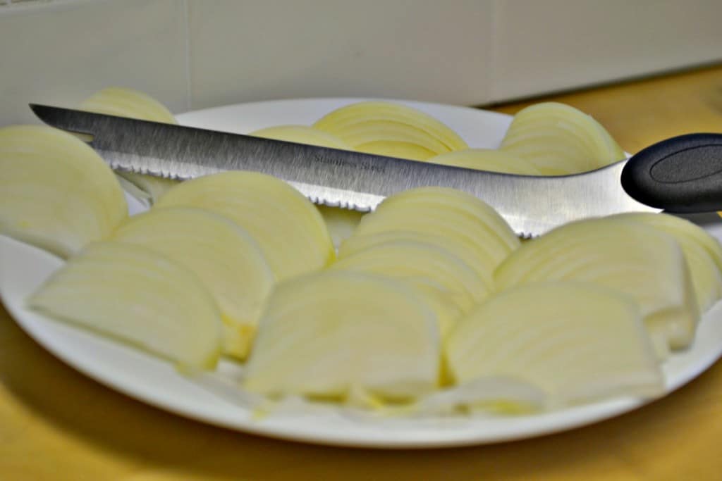 Peel onions and quarter into wedges.