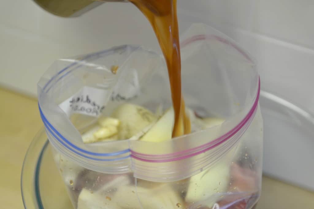 Add meat and vegetables to a large freezer bag and pout wine broth mixture over the meat. 