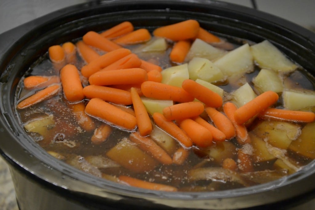 On cooking day place the marinated meat, sauce, carrots, and potatoes in the slow cooker. 