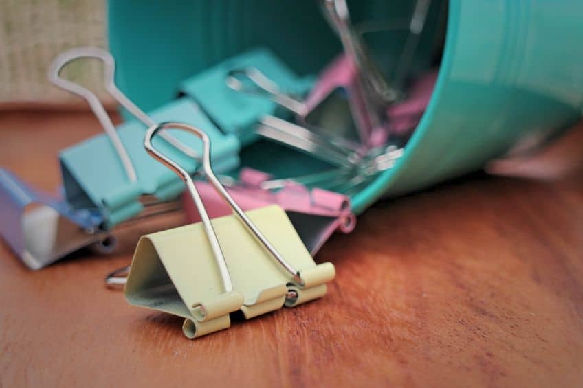 Repurpose binder clips to help organize electronic cords. 