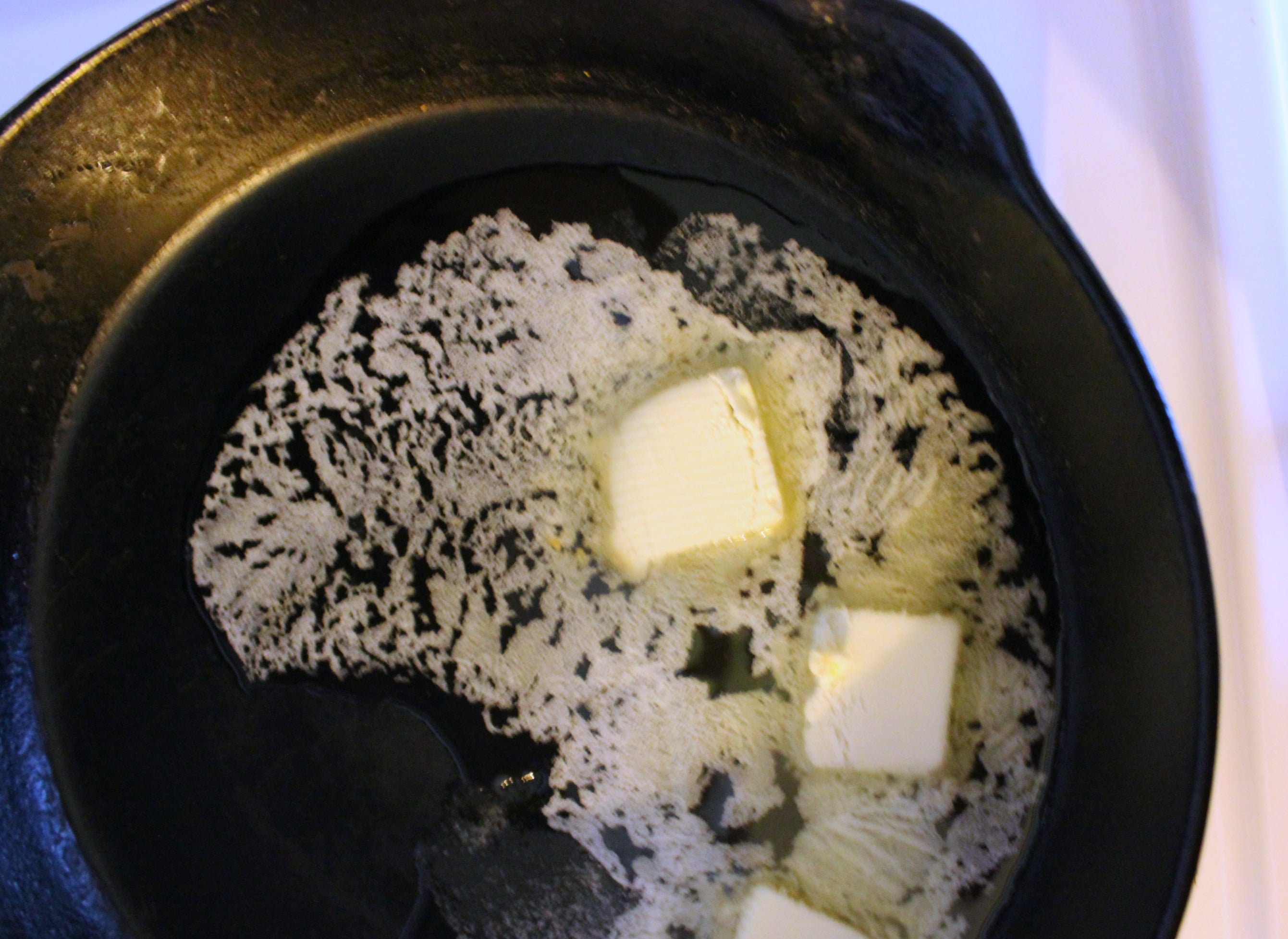 Melt 3 tablespoons of butter or coconut oil over medium heat.
