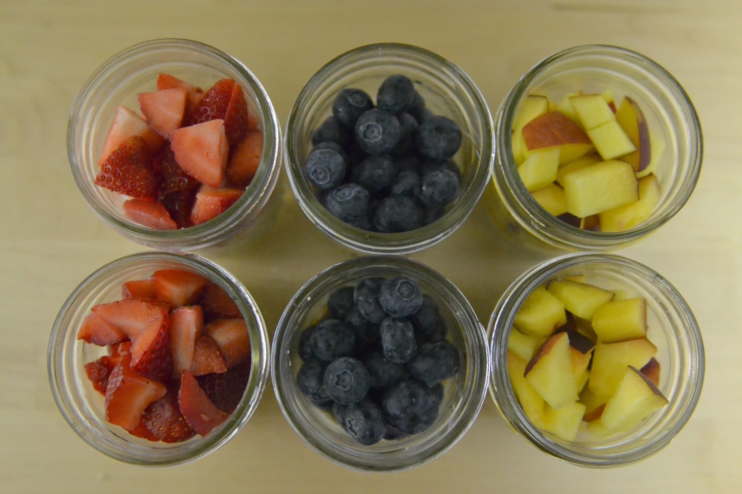 Top each jar with desired fruit and cover with mason jar lid